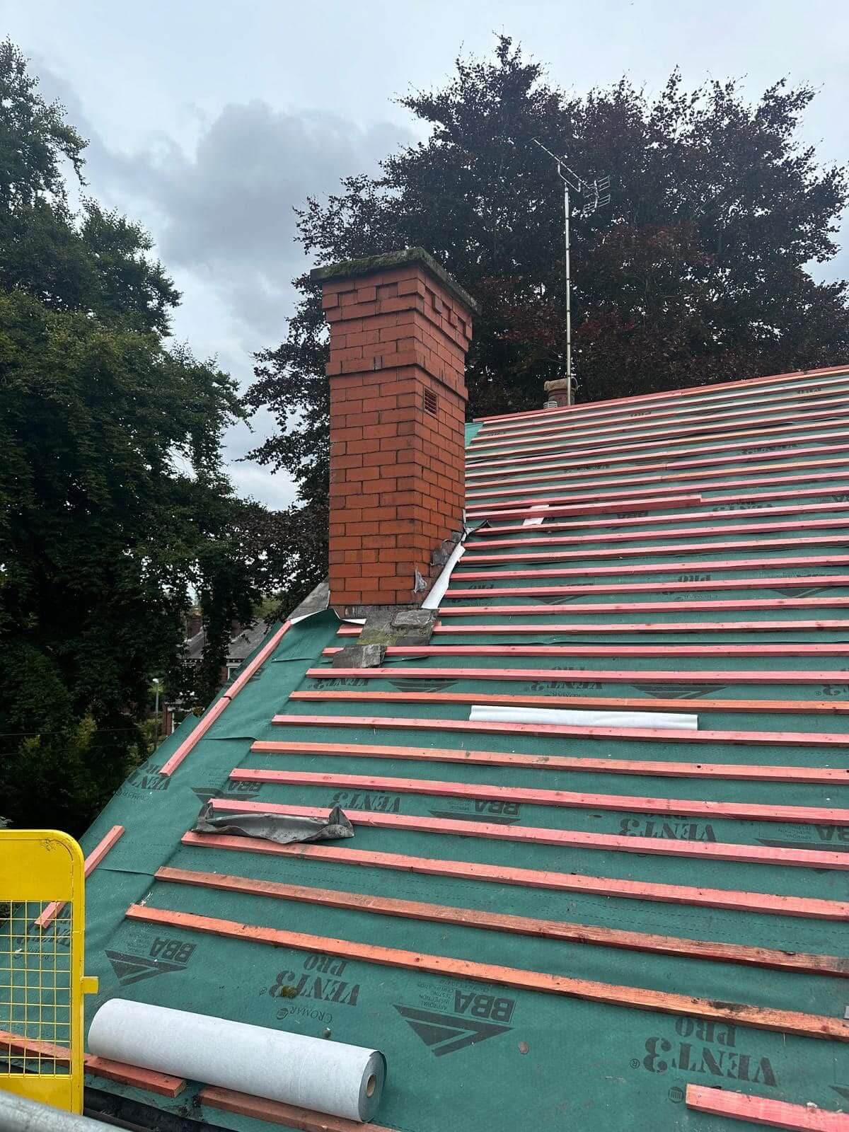 Chimney brickwork showing signs of harsh weathering before repointing in Wigan