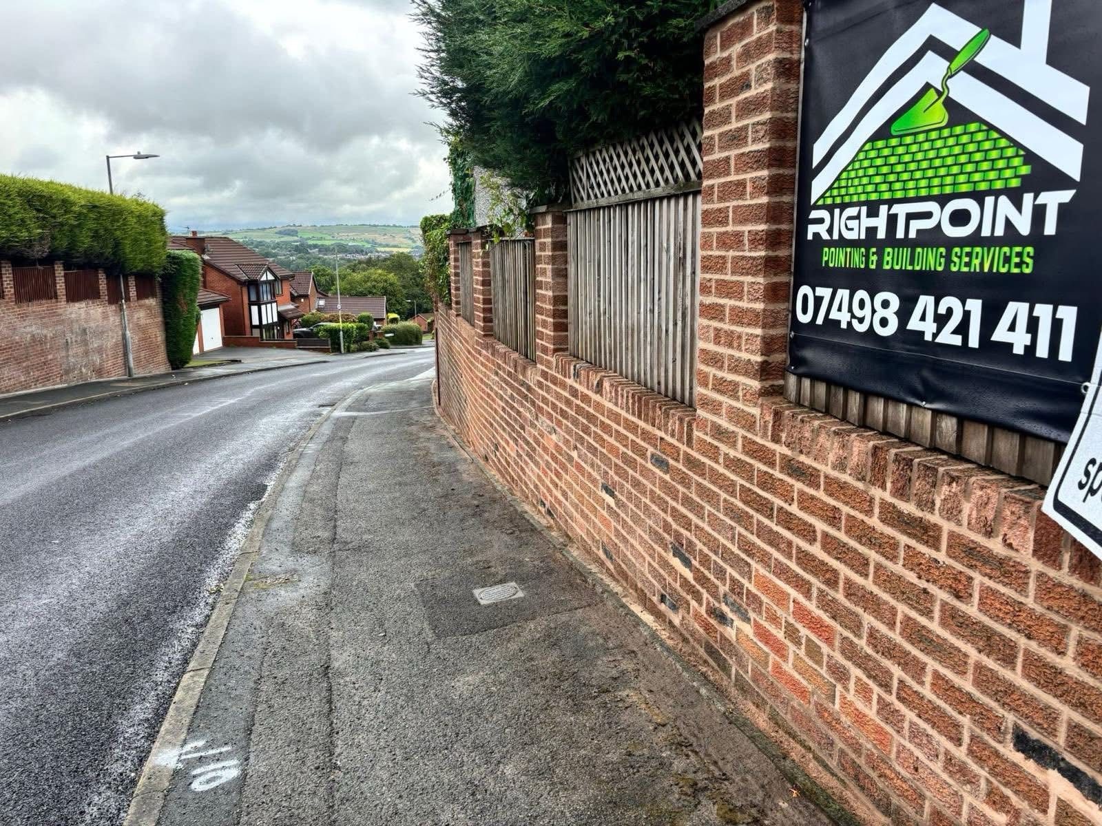Right Point signage on a repointed brick boundary wall on a residential street in Leigh