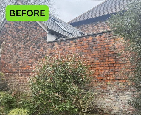 Weathered brick boundary wall in Manchester before repointing
