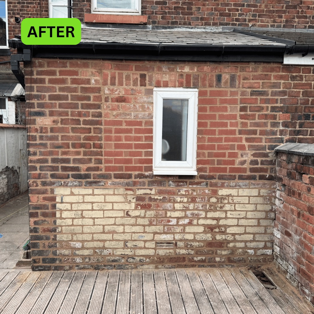 Rear brick wall after brickwork repairs on a terraced property in Wigan