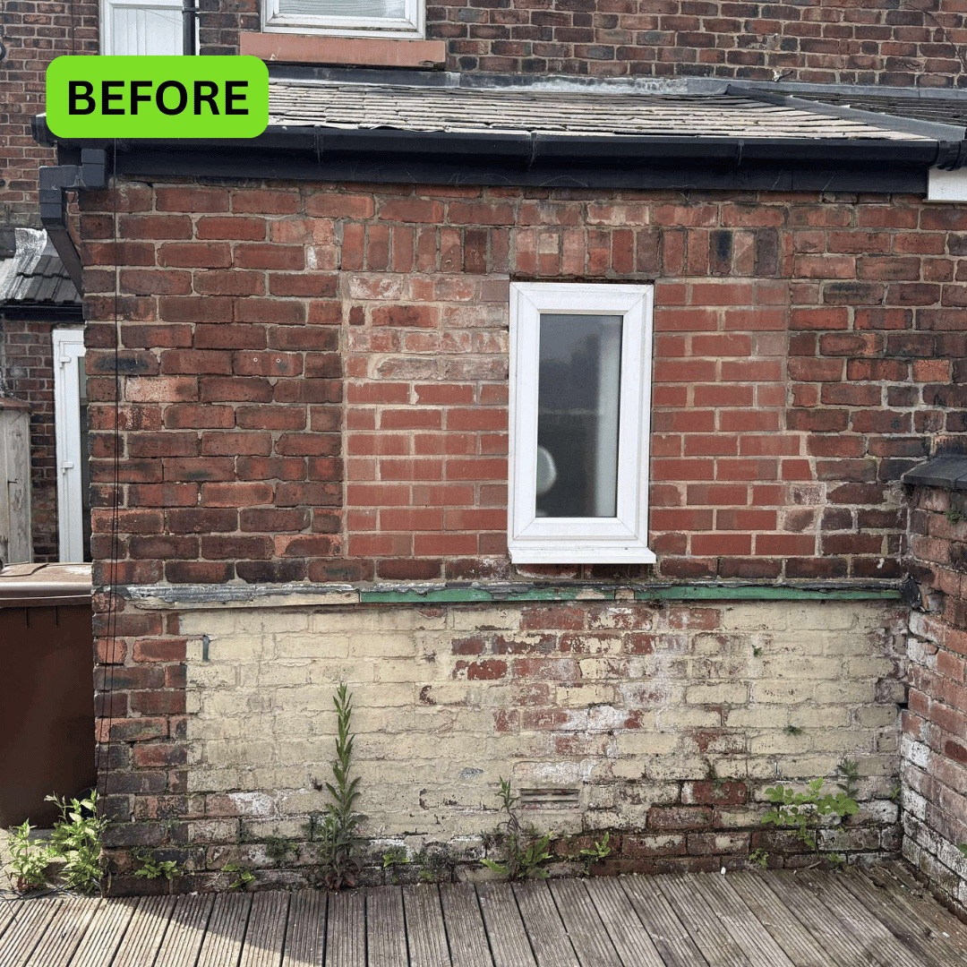 Rear brick wall before brickwork repairs on a terraced property in Wigan